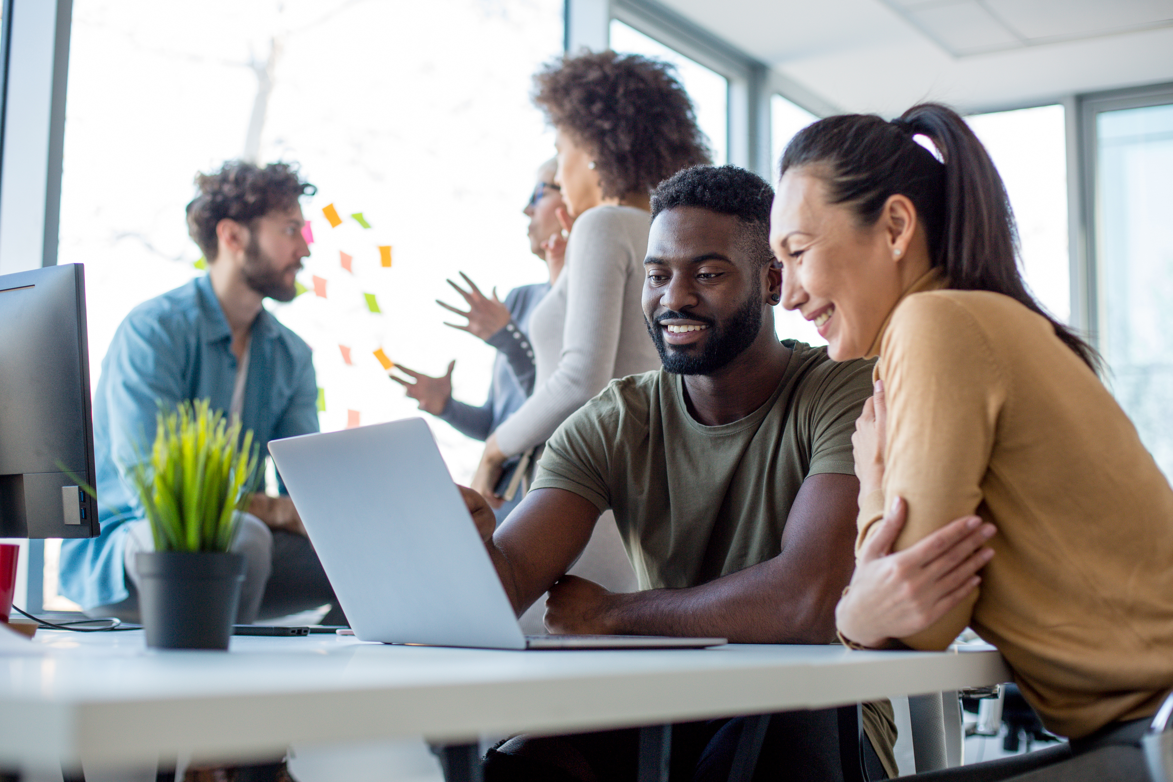 Young people looking at computer together