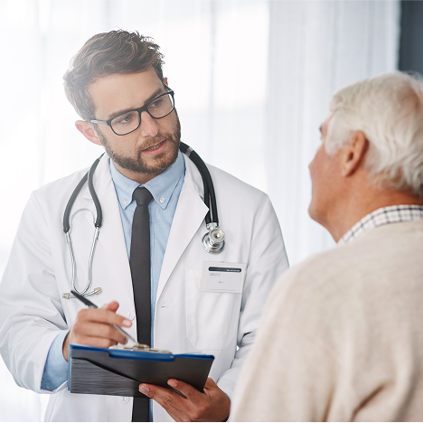 young-male-doctor-going-through-medical-records-with-his-senior-male-patient